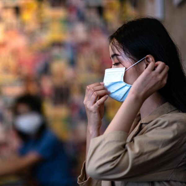 Young female woman wearing a fase mask