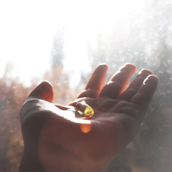 Hand with vitamin D supplement sunlight
