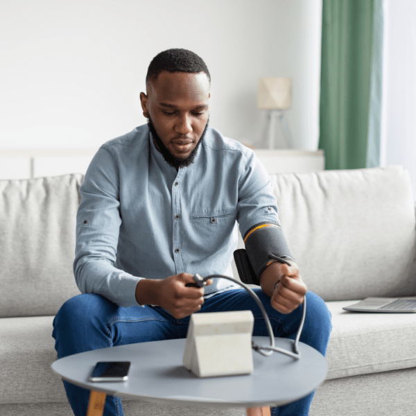 Man checking his blodd pressure at home
