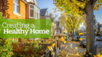 The street is filled with houses and beautiful trees during the fall season