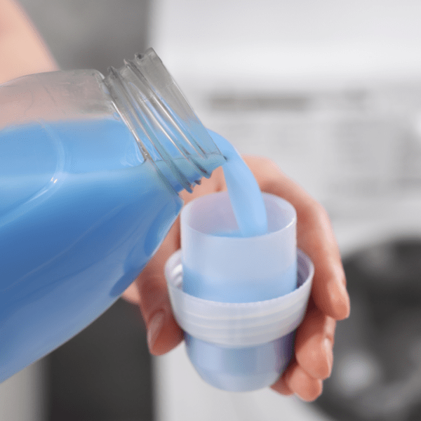 Person pouring fabric softener
