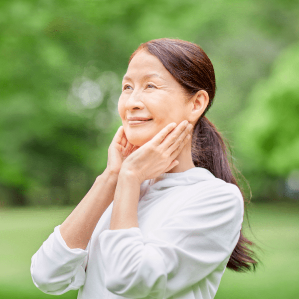 Happy middle aged woman surrounded by nature