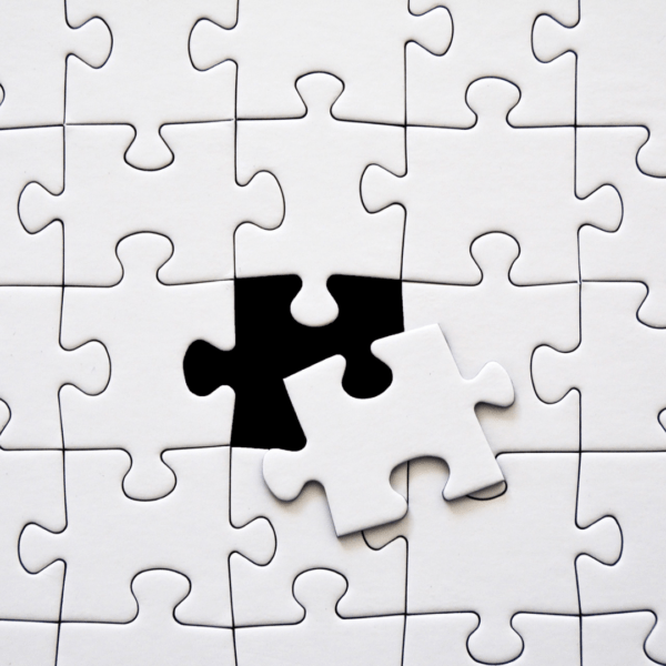 White puzzle piece fitting perfectly into an empty spot, representing magnesium as a missing piece in whole-body health.