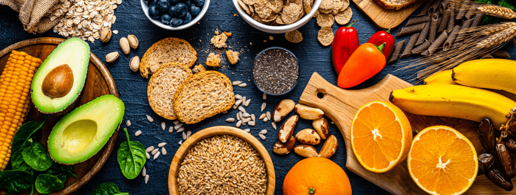 Selection of healthy carbohydrates and fiber-rich foods like grains, fruits, vegetables, and seeds, promoting balanced nutrition during menopause.