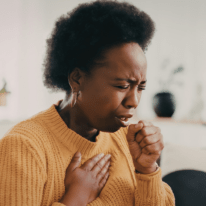 an image of a woman coughing