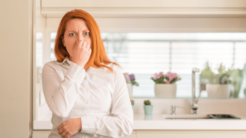 Woman holding her nose because something stinks