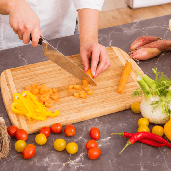 Woman chopping vegetables preparing her meal