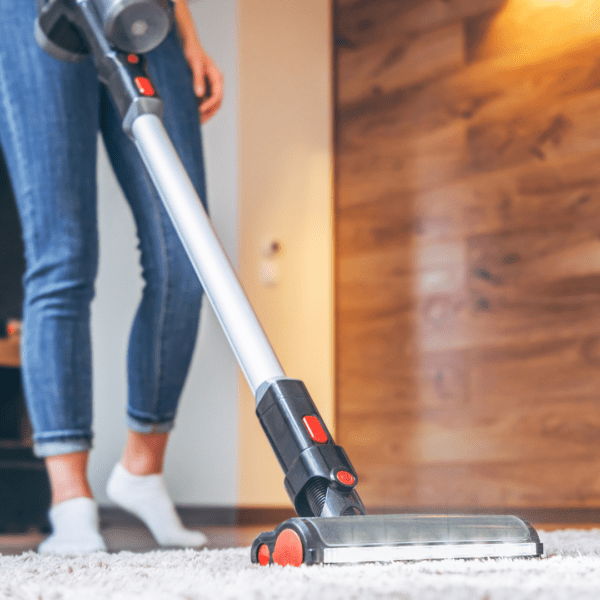 Woman vacuuming carpet