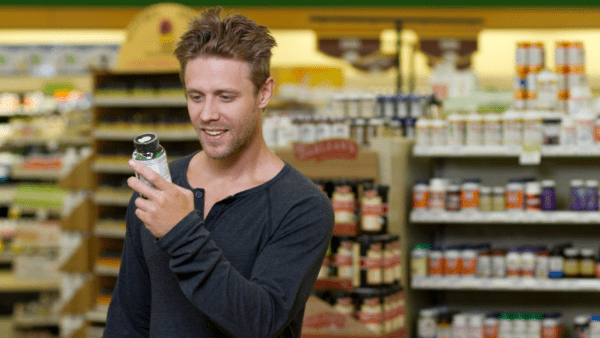 Man buying supplement checking label