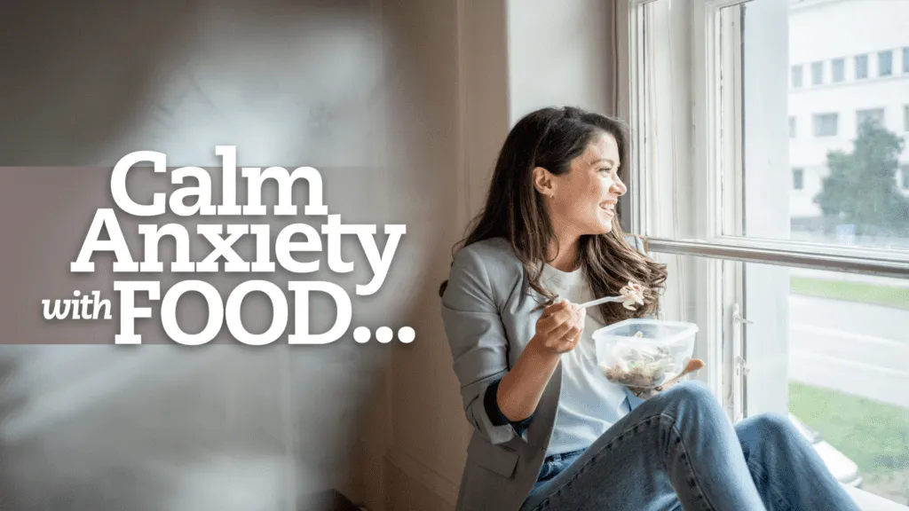 Smiling woman sitting by a bright window, eating a fresh salad from a container. Text overlay reads &ldquo;Calm Anxiety with FOOD&hellip;&rdquo; suggesting the connection between nutrition and emotional well-being