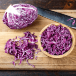 purple cabbage sliced in a wooden chopping board