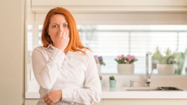 Woman holding her nose because something stinks