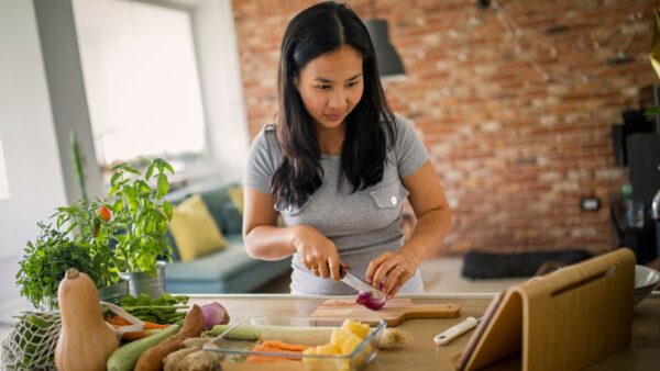 Young-Asian-Woman-Chopping-Vegetables
