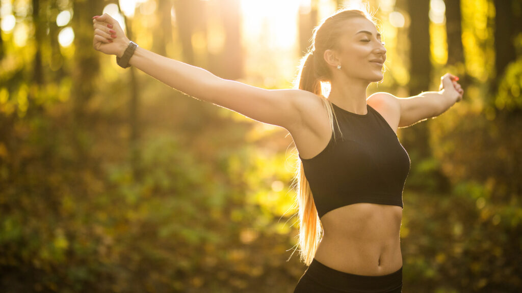 Woman working out in the woods enjoying nature