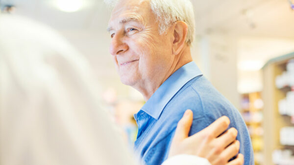 Smiling Senior Man Looking At Pharmacist