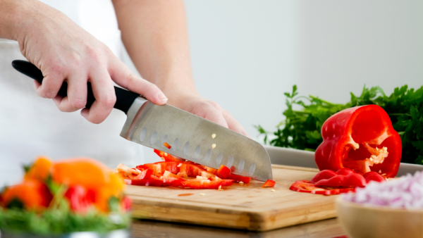 Woman chopping vegetables preparing a meal