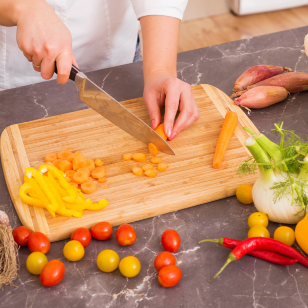 Woman chopping vegetables preparing her meal