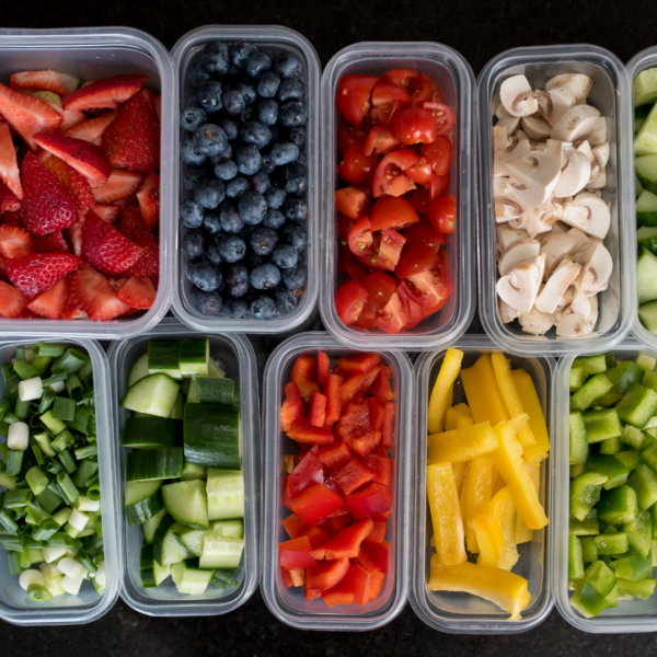 Lunch boxes with chopped fruits and vegetables