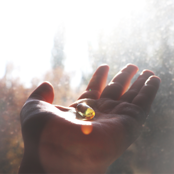 Hand with vitamin D supplement sunlight