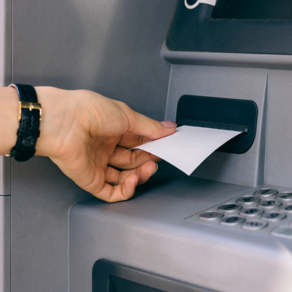 Person getting a receipt from an ATM