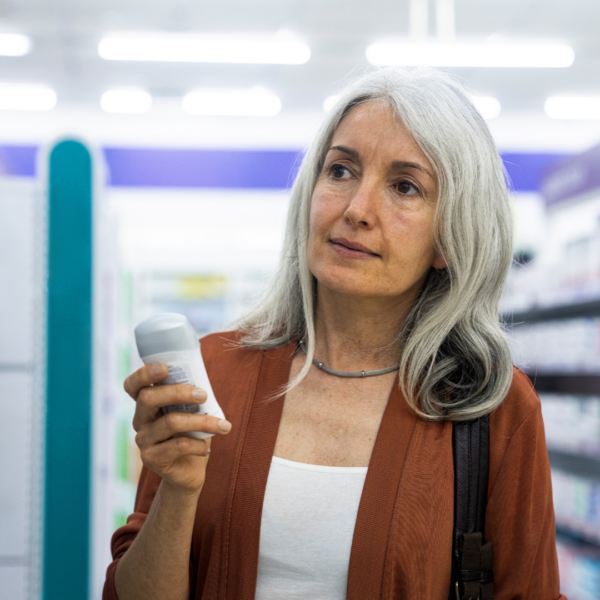 Middle-aged woman in the supermarket checking for deodorants