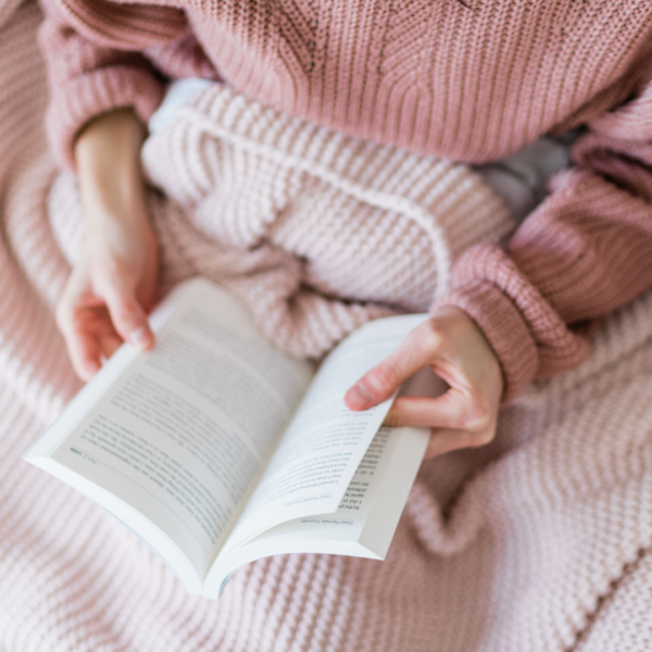 Girl reading a book in bed