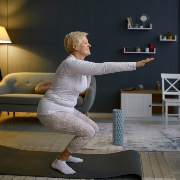 Middle aged woman doing quick squats at home