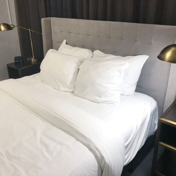 Clean white bed with new sheets