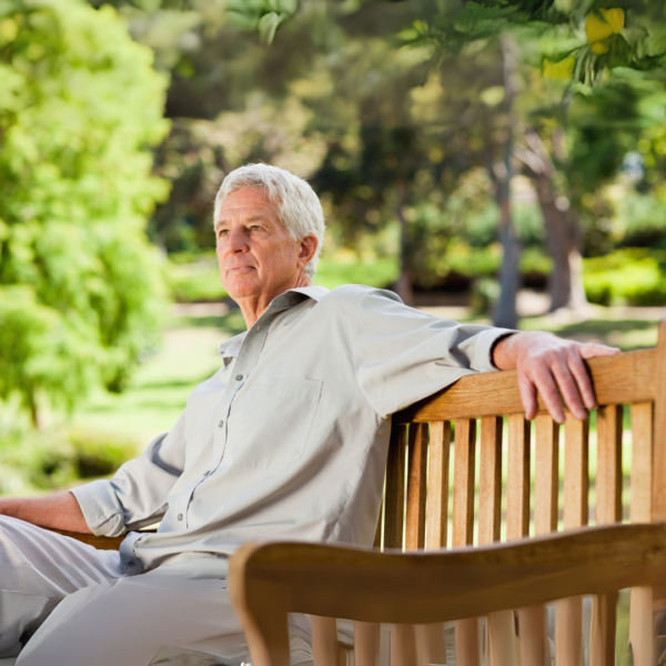 Older man relaxing on a park bench, symbolizing calmness, heart health, and aging gracefully with mineral support.