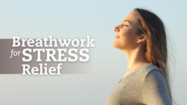 Woman Breathing Outdoor A young woman stands outdoors in profile, eyes closed and smiling peacefully while taking a deep breath.