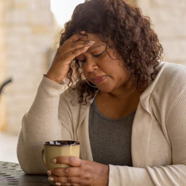 Woman in her 40s with her hand on her head, looking worried