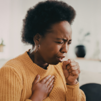 an image of a woman coughing