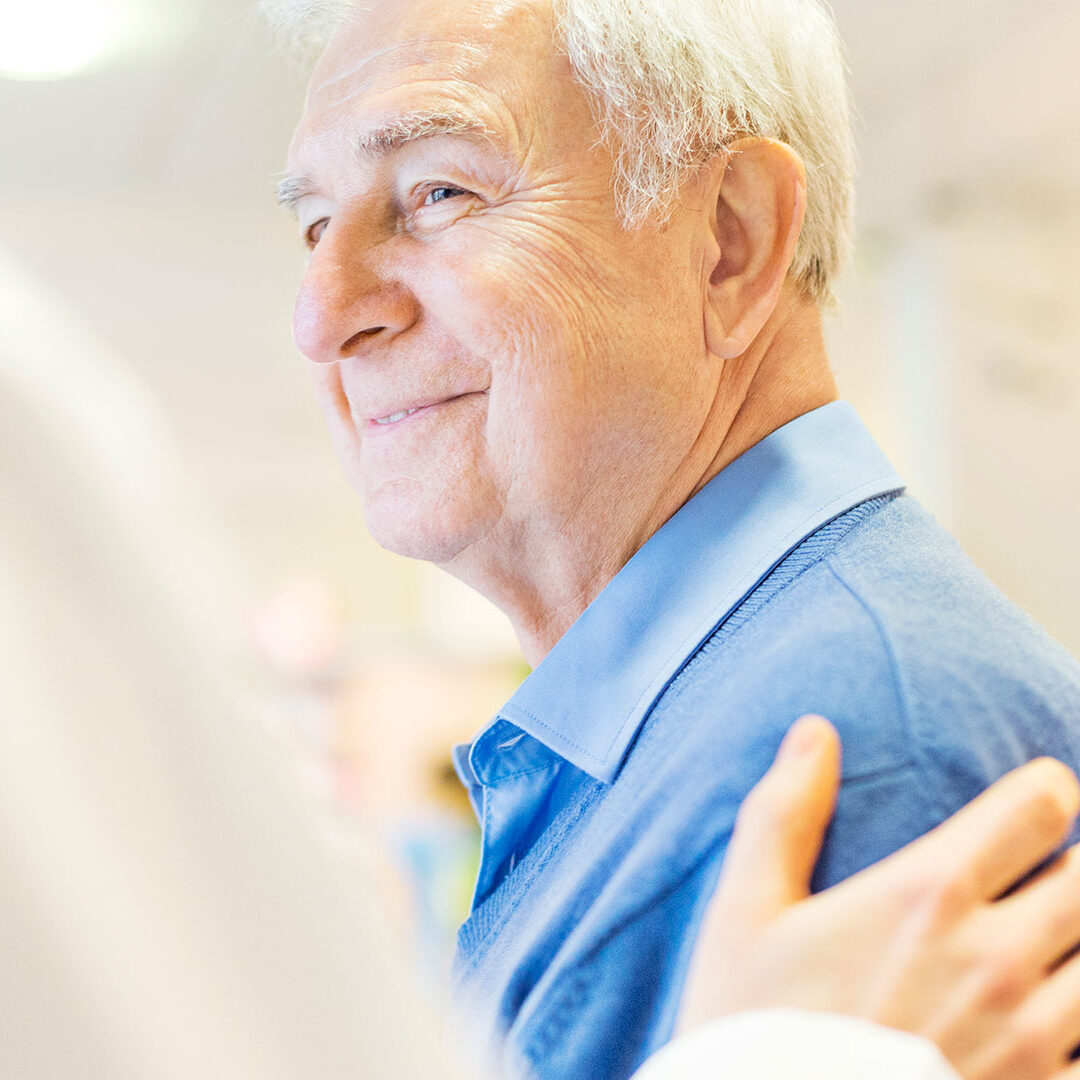 Smiling Senior Man Looking At Pharmacist